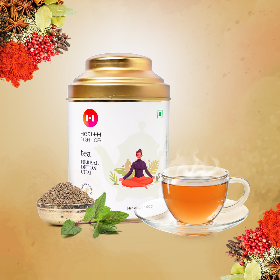 A package of Health Platter Herbal Detox Chai tea with a cup of tea and a pot on a background with decorative flowers and a figure sitting cross-legged.