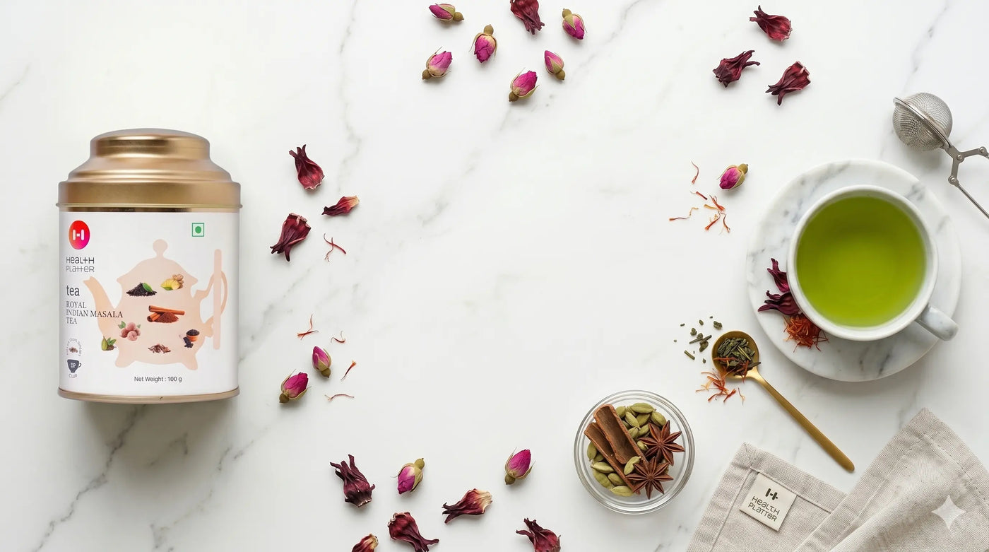 A warm cup of Health Platter specialty green tea surrounded by natural medicinal herbs and plant-based health supplements.